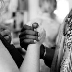 Cultural Diversity - grayscale photo of man and woman holding their hands