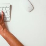 Volunteer Manage - person typing on Apple Cordless Keyboard