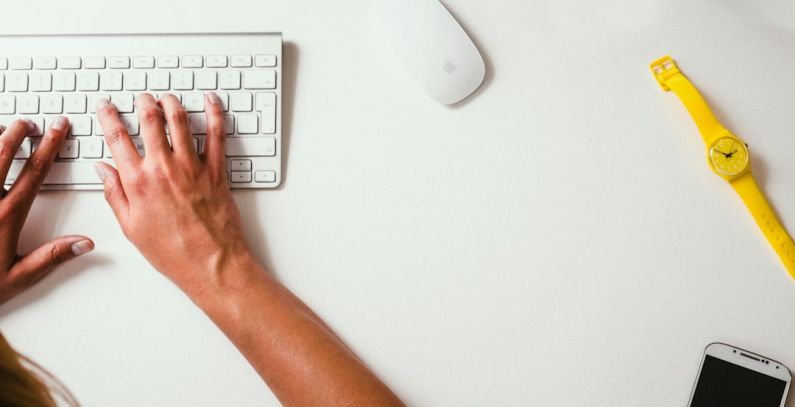 Volunteer Manage - person typing on Apple Cordless Keyboard