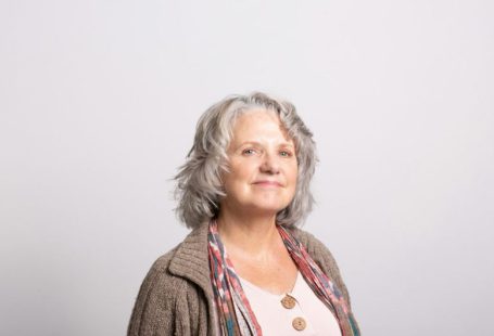 Age Diversity - a woman with grey hair wearing a brown cardigan