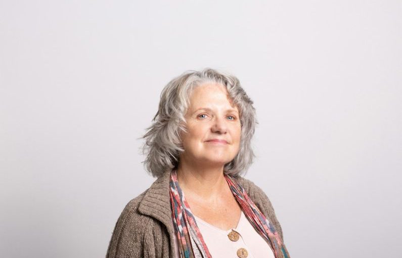 Age Diversity - a woman with grey hair wearing a brown cardigan