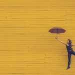 Social Media Question - woman holding brown umbrella