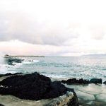 Culture Sensitivity - a large body of water next to a rocky shore