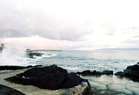 Culture Sensitivity - a large body of water next to a rocky shore