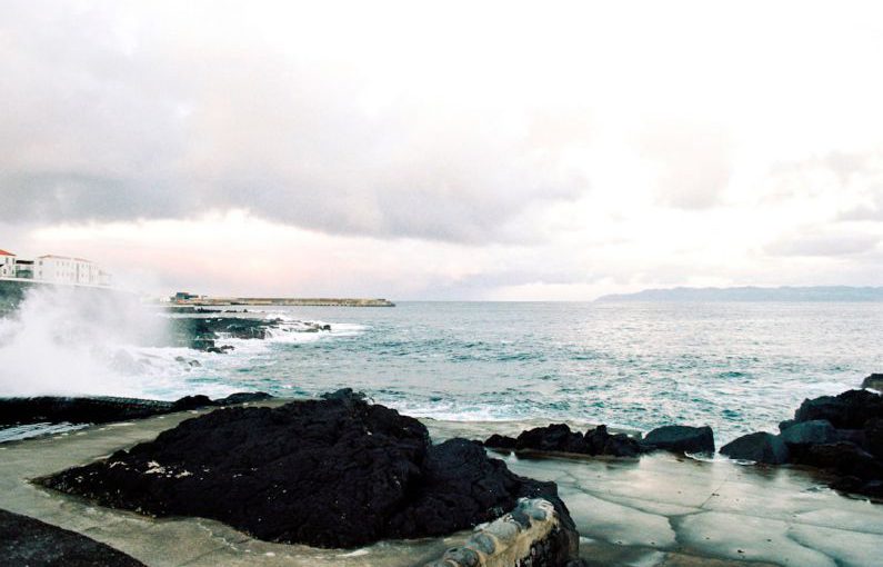 Culture Sensitivity - a large body of water next to a rocky shore