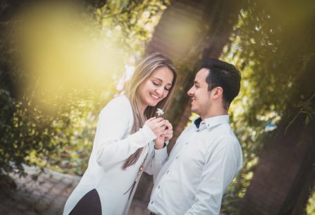 Introverts Engage - man giving white flower to woman surrounded by green trees