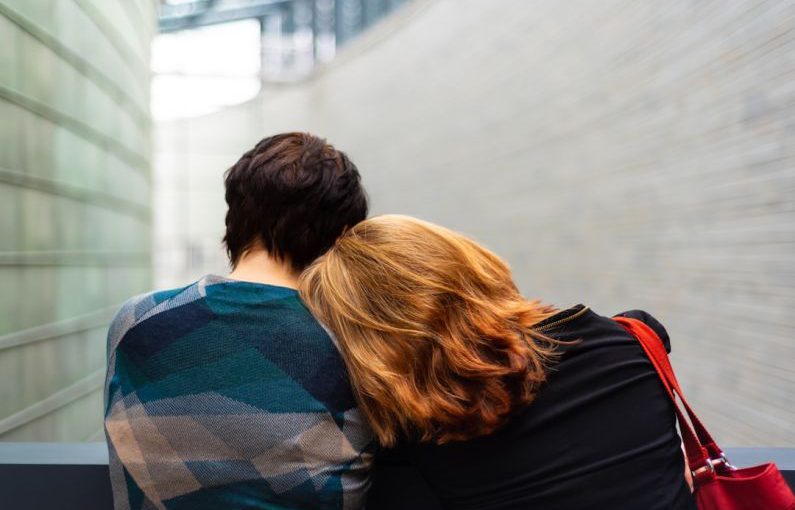 Burnout Recovery - a woman rests her head on another person's shoulder