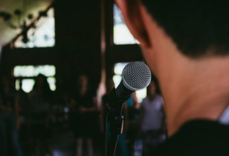 Public Speaking - man standing in front of microphone