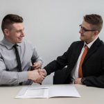 Partnership Benefits - two men facing each other while shake hands and smiling