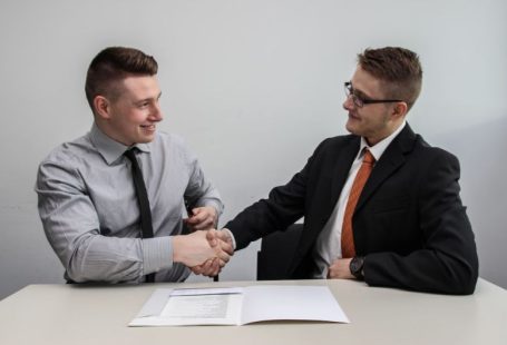 Partnership Benefits - two men facing each other while shake hands and smiling