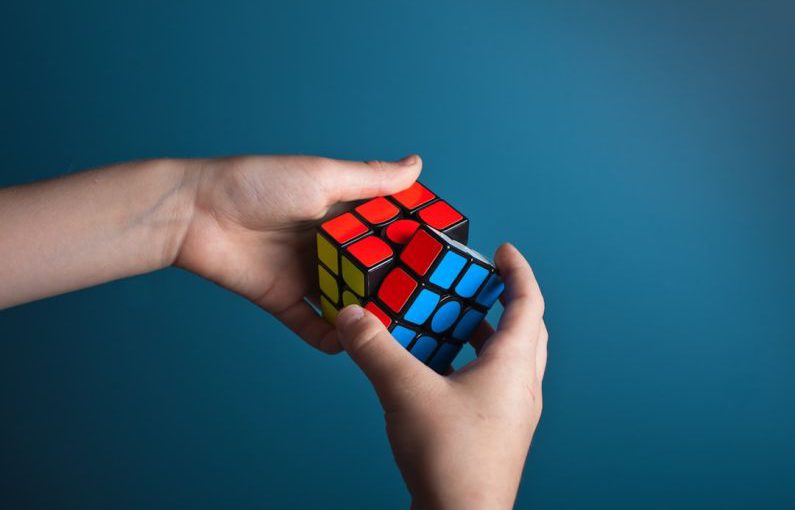 Problem Solving - person playing magic cube