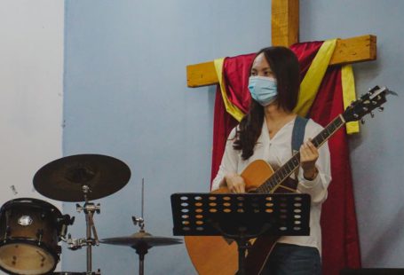 Youth Empowerment - woman in white long sleeve shirt playing guitar