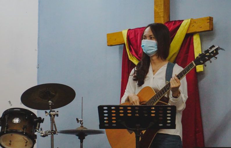 Youth Empowerment - woman in white long sleeve shirt playing guitar