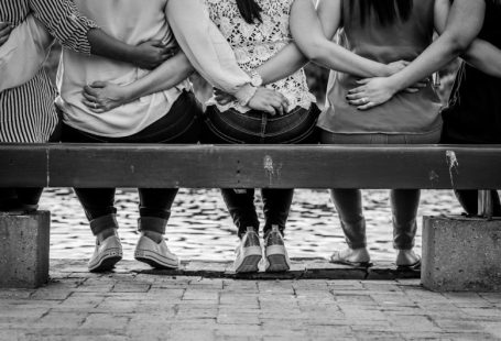 Women Empowerment - grayscale photo of 3 women sitting on wooden bench