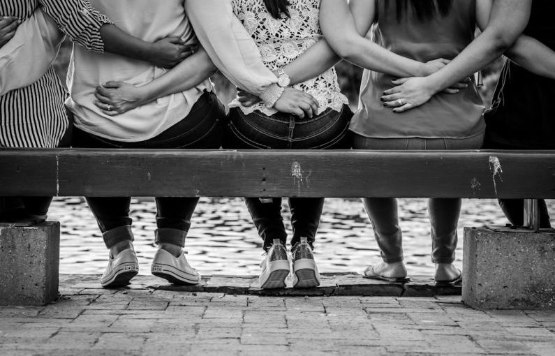 Women Empowerment - grayscale photo of 3 women sitting on wooden bench