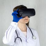 Vision Reality - a woman in a white coat and blue gloves is wearing a virtual headset