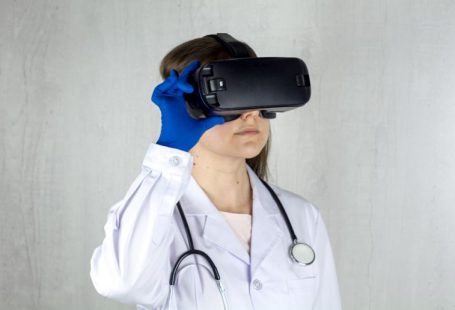 Vision Reality - a woman in a white coat and blue gloves is wearing a virtual headset