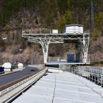 Platform Guide - a train traveling over a bridge next to a mountain