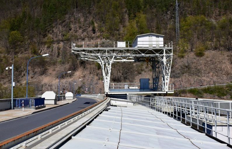 Platform Guide - a train traveling over a bridge next to a mountain