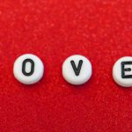 Message Craft - the word love spelled out in small letters on a red surface