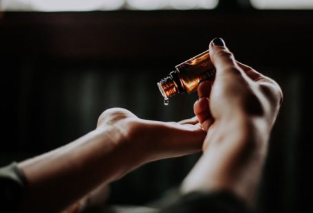 Self-care Tips - person holding amber glass bottle