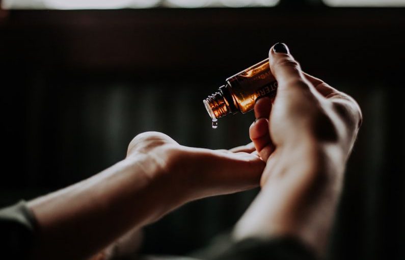 Self-care Tips - person holding amber glass bottle