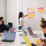 Visual Communication - woman placing sticky notes on wall